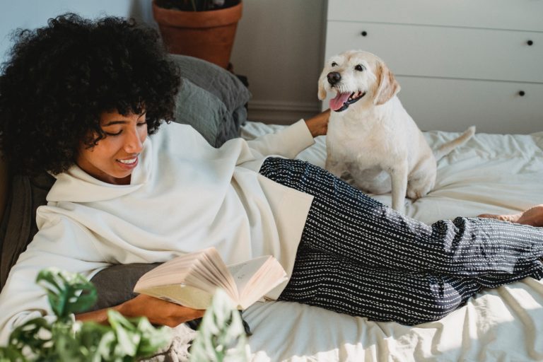 a person lying down with a dog